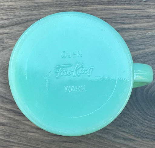 Close-up of a flat-bottomed Fire-King Jadeite shaving mug.
