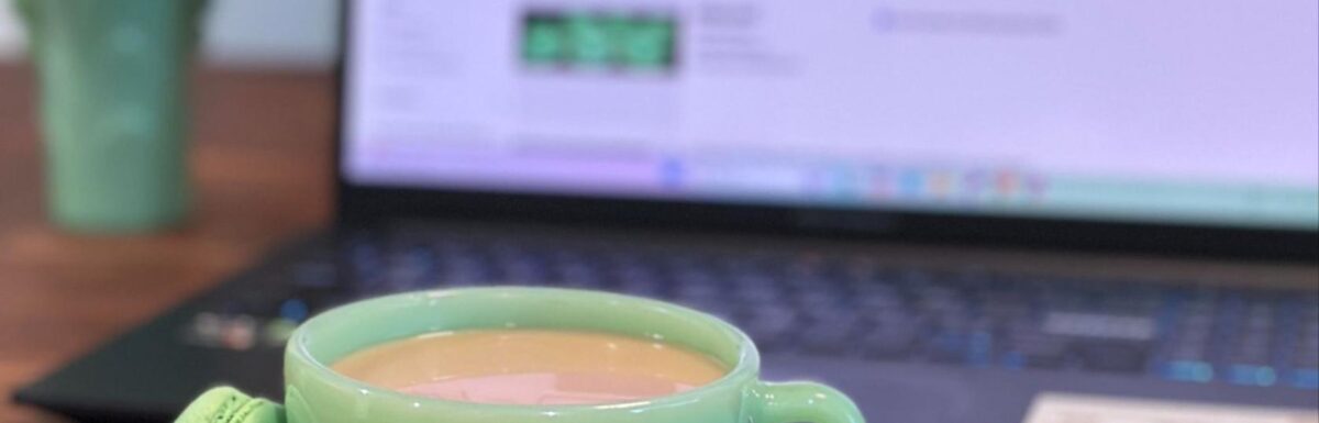 Fire-king Restaurant Ware Jadeite cup and saucer with macarons and "What's it Worth?" tag, styled in front of a laptop displaying Jadeite eBay listings